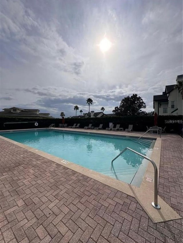 view of swimming pool featuring a patio area