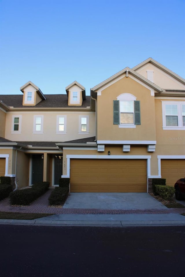 multi unit property featuring a garage