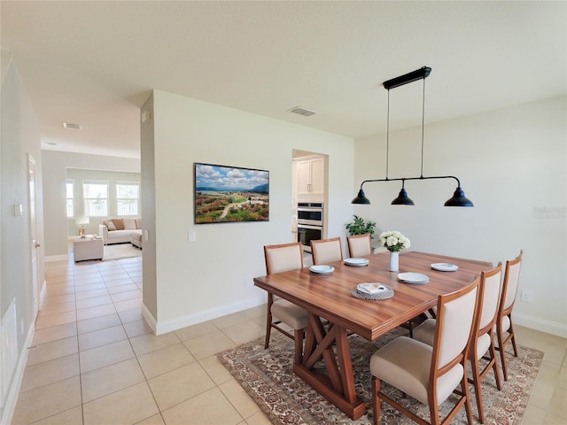 dining space featuring light tile patterned floors