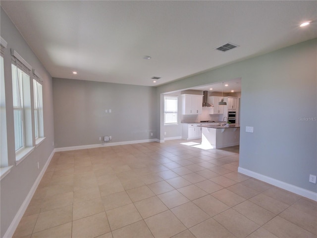 unfurnished living room featuring light tile patterned floors