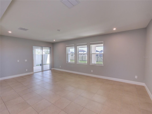 tiled empty room with a healthy amount of sunlight