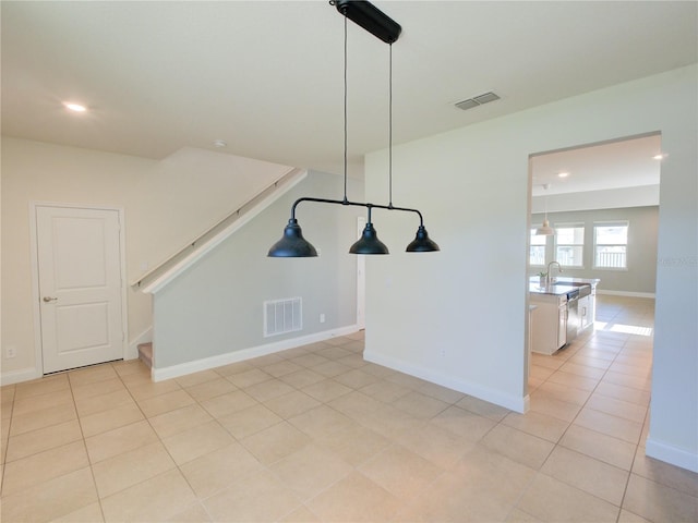 unfurnished dining area featuring light tile patterned flooring