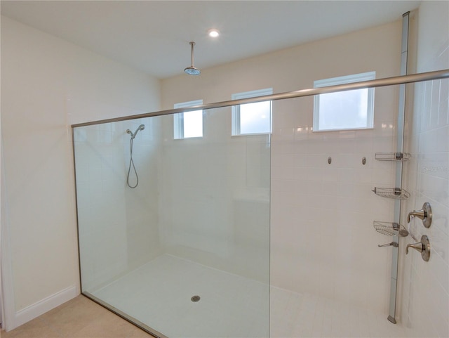 bathroom with tile patterned floors and an enclosed shower