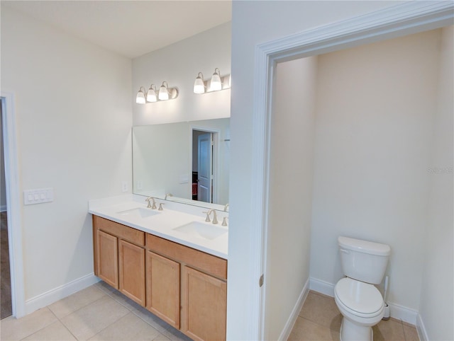 bathroom featuring tile patterned floors, vanity, and toilet