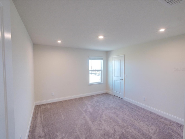 empty room featuring light carpet