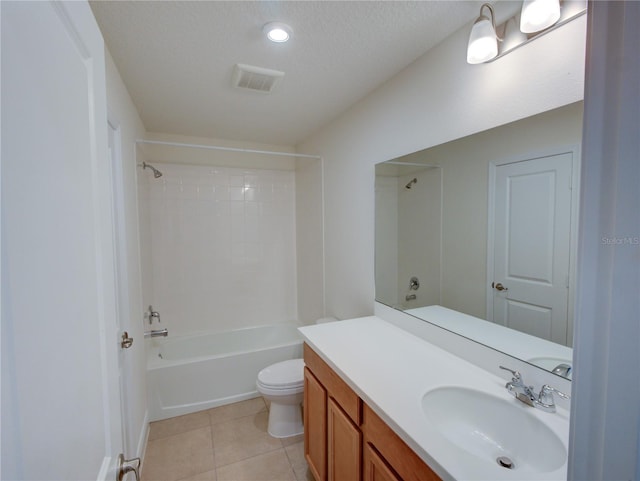 full bathroom with tile patterned floors, a textured ceiling, toilet, vanity, and bathtub / shower combination