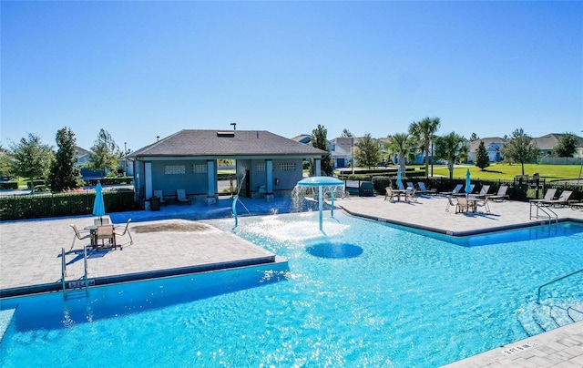 view of swimming pool with a patio and pool water feature