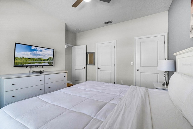 bedroom with a textured ceiling and ceiling fan