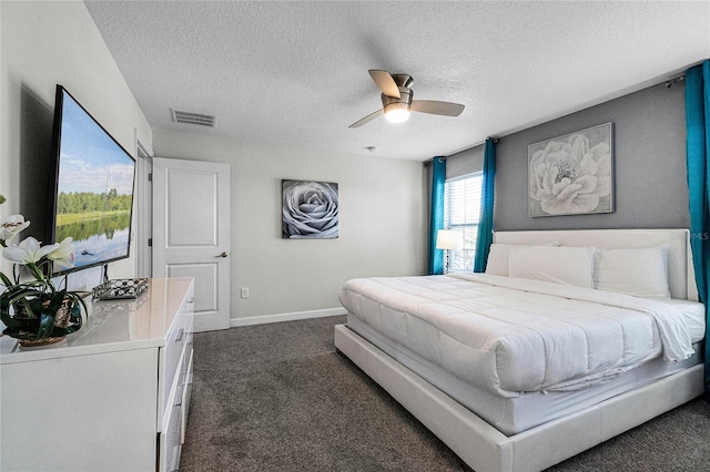 carpeted bedroom with ceiling fan and a textured ceiling