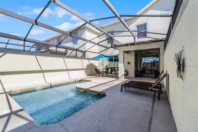 view of pool featuring a lanai, ceiling fan, and a patio