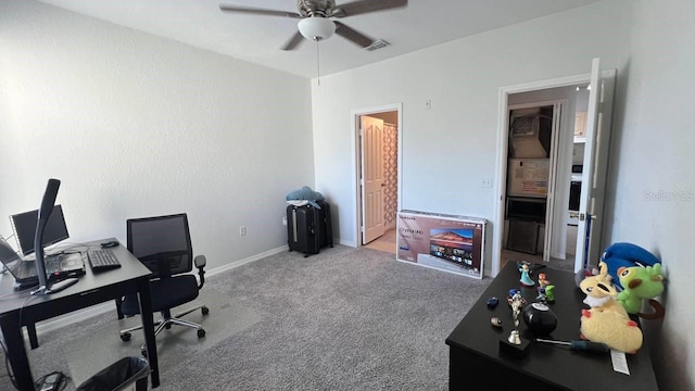 carpeted home office with ceiling fan