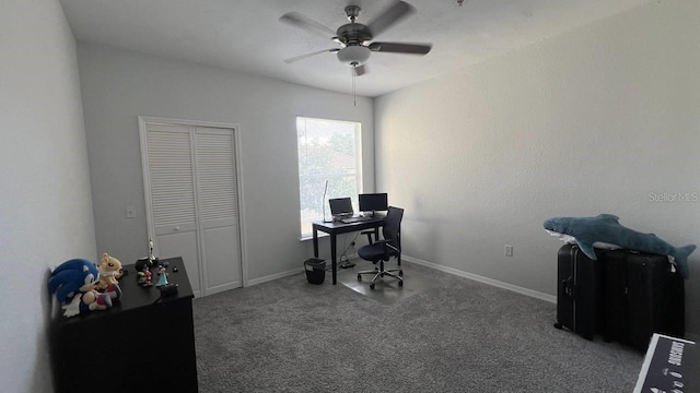 carpeted home office featuring ceiling fan