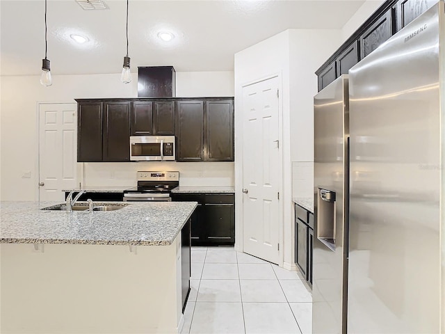 kitchen with pendant lighting, sink, light stone countertops, appliances with stainless steel finishes, and light tile patterned flooring