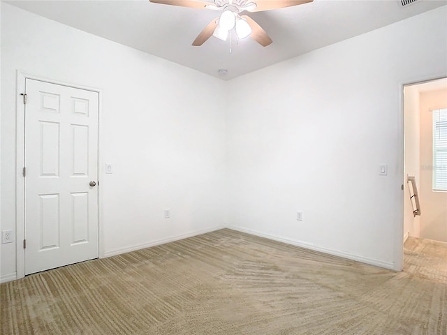 empty room with carpet flooring and ceiling fan