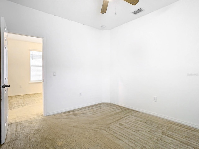 carpeted empty room featuring ceiling fan