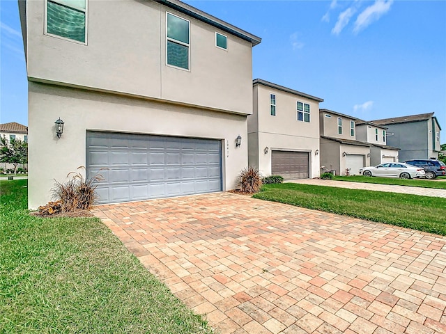 view of front of property with a garage and a front lawn