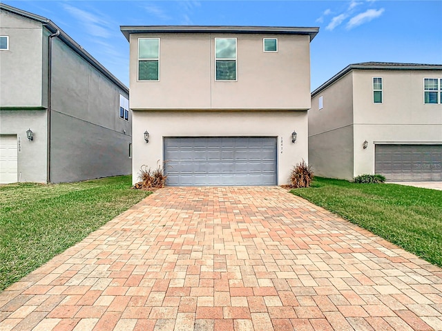 front of property with a front yard and a garage