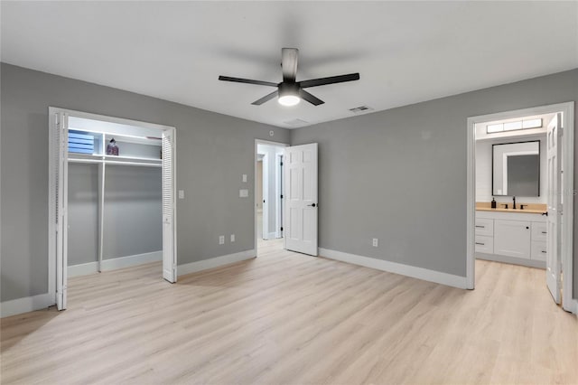 unfurnished bedroom with ceiling fan, light wood-type flooring, connected bathroom, and a closet