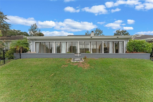 rear view of property with a yard