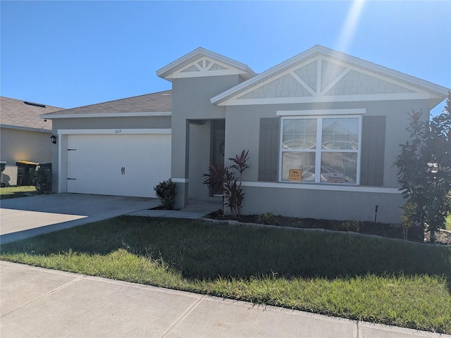 view of front facade with a garage and a front lawn