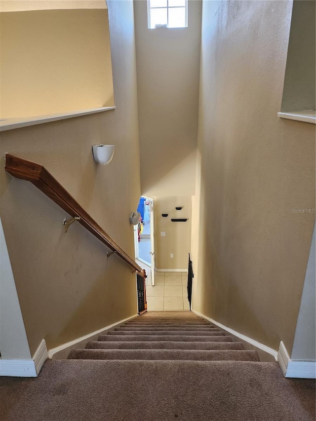 stairs featuring carpet flooring