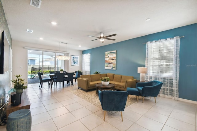 living room featuring light tile patterned floors and ceiling fan