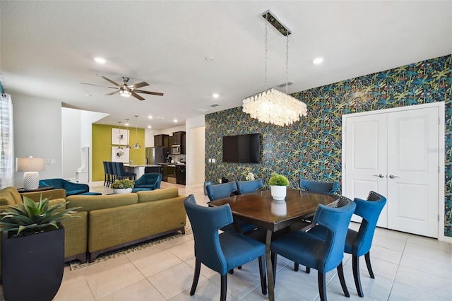 dining room featuring ceiling fan with notable chandelier and light tile patterned floors