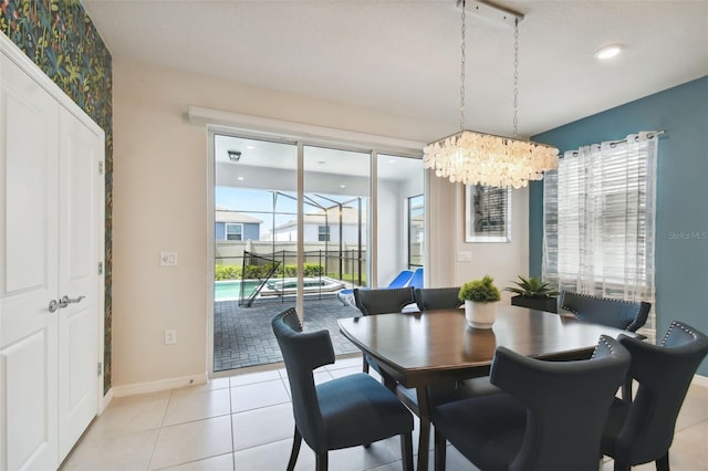 dining area featuring light tile patterned floors and an inviting chandelier