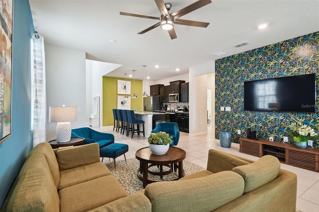 tiled living room featuring ceiling fan and a healthy amount of sunlight