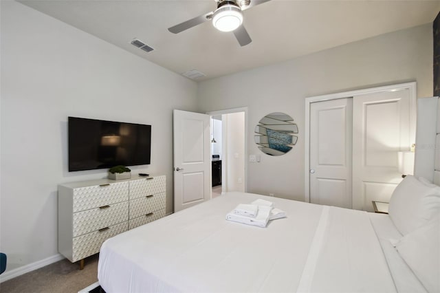 carpeted bedroom featuring a closet and ceiling fan