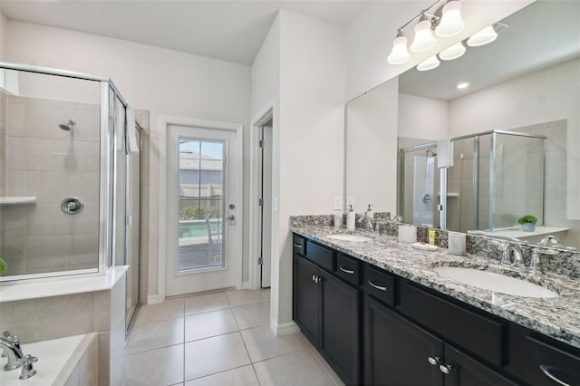 bathroom with tile patterned floors, vanity, and independent shower and bath