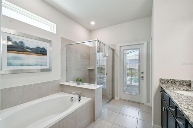 bathroom with tile patterned floors, independent shower and bath, and a wealth of natural light