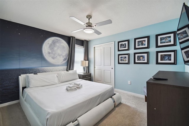 carpeted bedroom with ceiling fan, a textured ceiling, and a closet