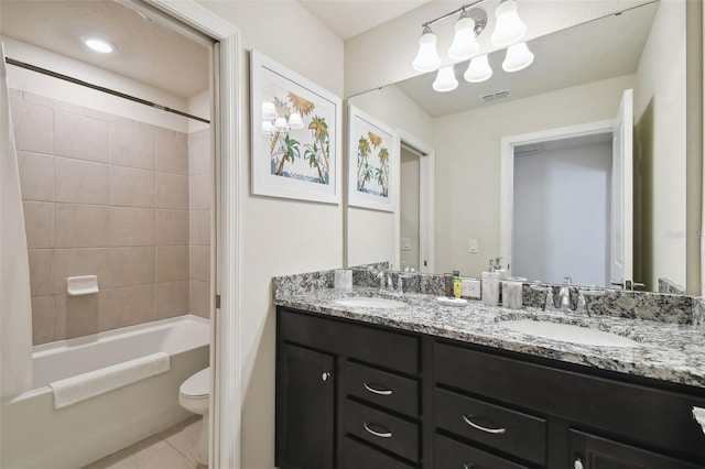 full bathroom featuring tile patterned flooring, vanity, toilet, and tiled shower / bath