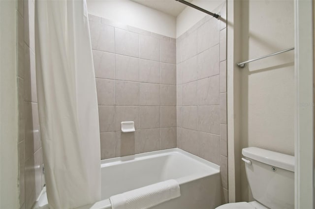 bathroom featuring toilet and shower / tub combo with curtain