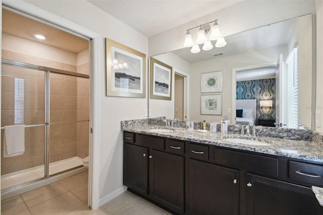 bathroom featuring tile patterned floors, vanity, toilet, and a shower with door