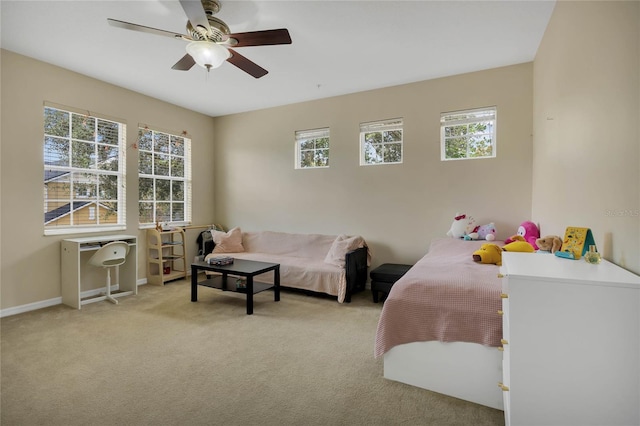 carpeted bedroom featuring ceiling fan and multiple windows