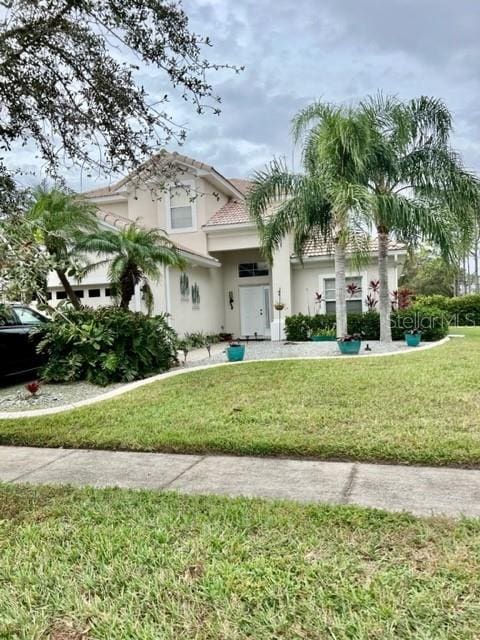 mediterranean / spanish-style house featuring a front lawn