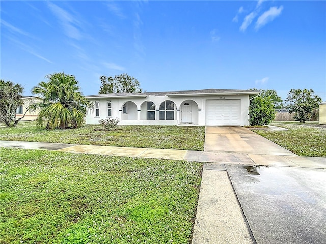 ranch-style home featuring a front lawn and a garage