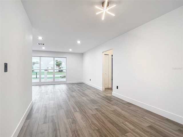 empty room with hardwood / wood-style floors