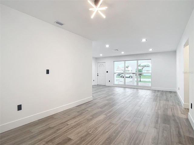 spare room featuring light wood-type flooring