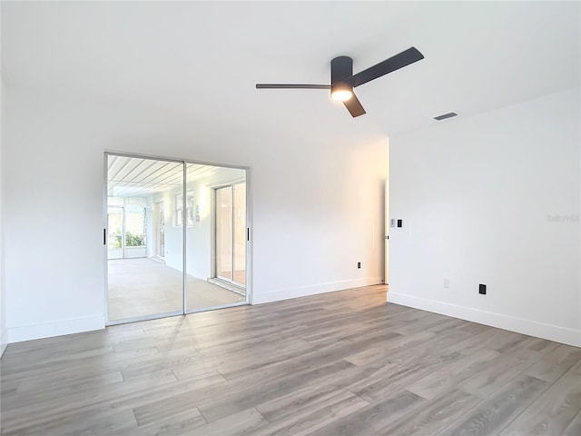 spare room with light hardwood / wood-style flooring and ceiling fan with notable chandelier