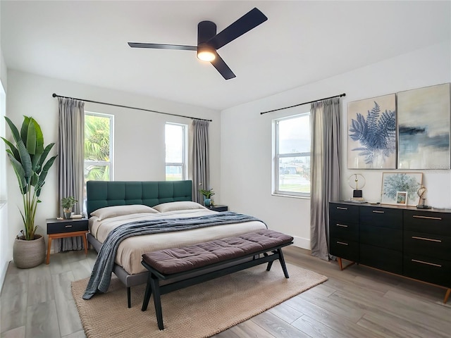 bedroom featuring light wood-type flooring and ceiling fan