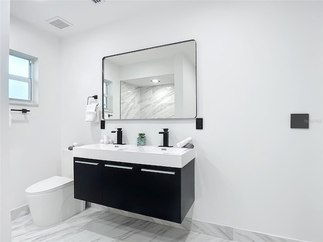 bathroom featuring walk in shower, vanity, and toilet