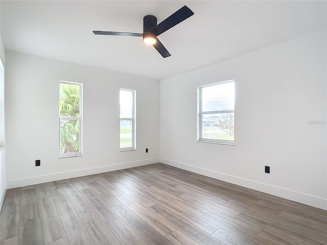 unfurnished room with ceiling fan and wood-type flooring