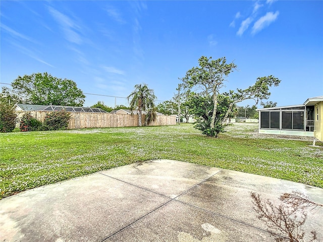 view of yard featuring a patio area and a sunroom