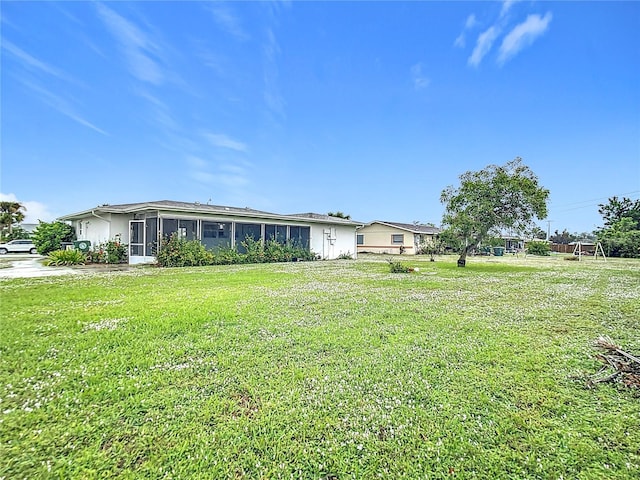 view of yard featuring a sunroom