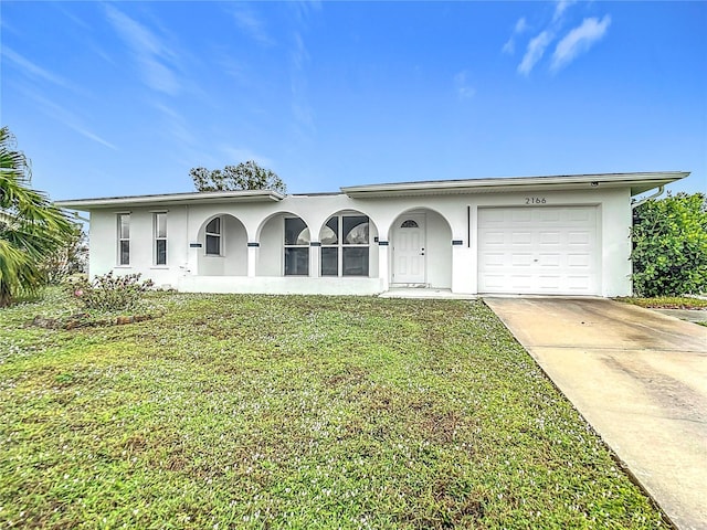 ranch-style house with a front yard and a garage