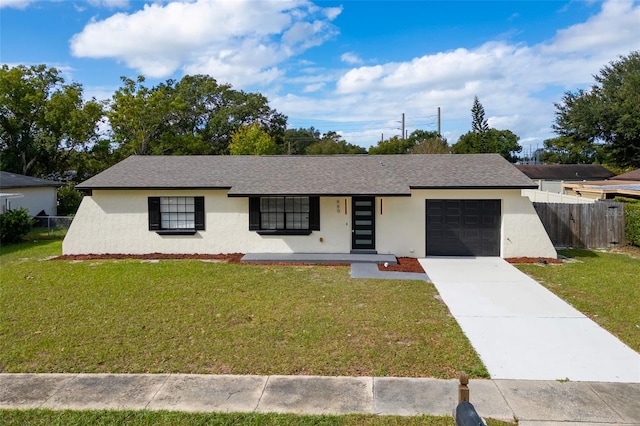 ranch-style home with covered porch, a garage, and a front lawn