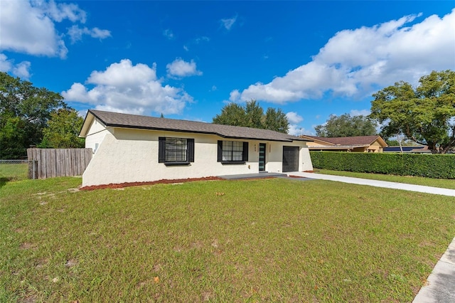 view of front facade with a garage and a front lawn